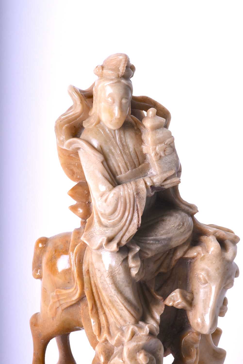 A Chinese carved soapstone figure of Guan Yin, late Qing, carved holding a vase and seated upon a - Image 2 of 4