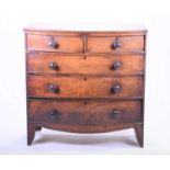 An early Victorian mahogany bow front chest of drawers with turned wood handles, on splayed legs,