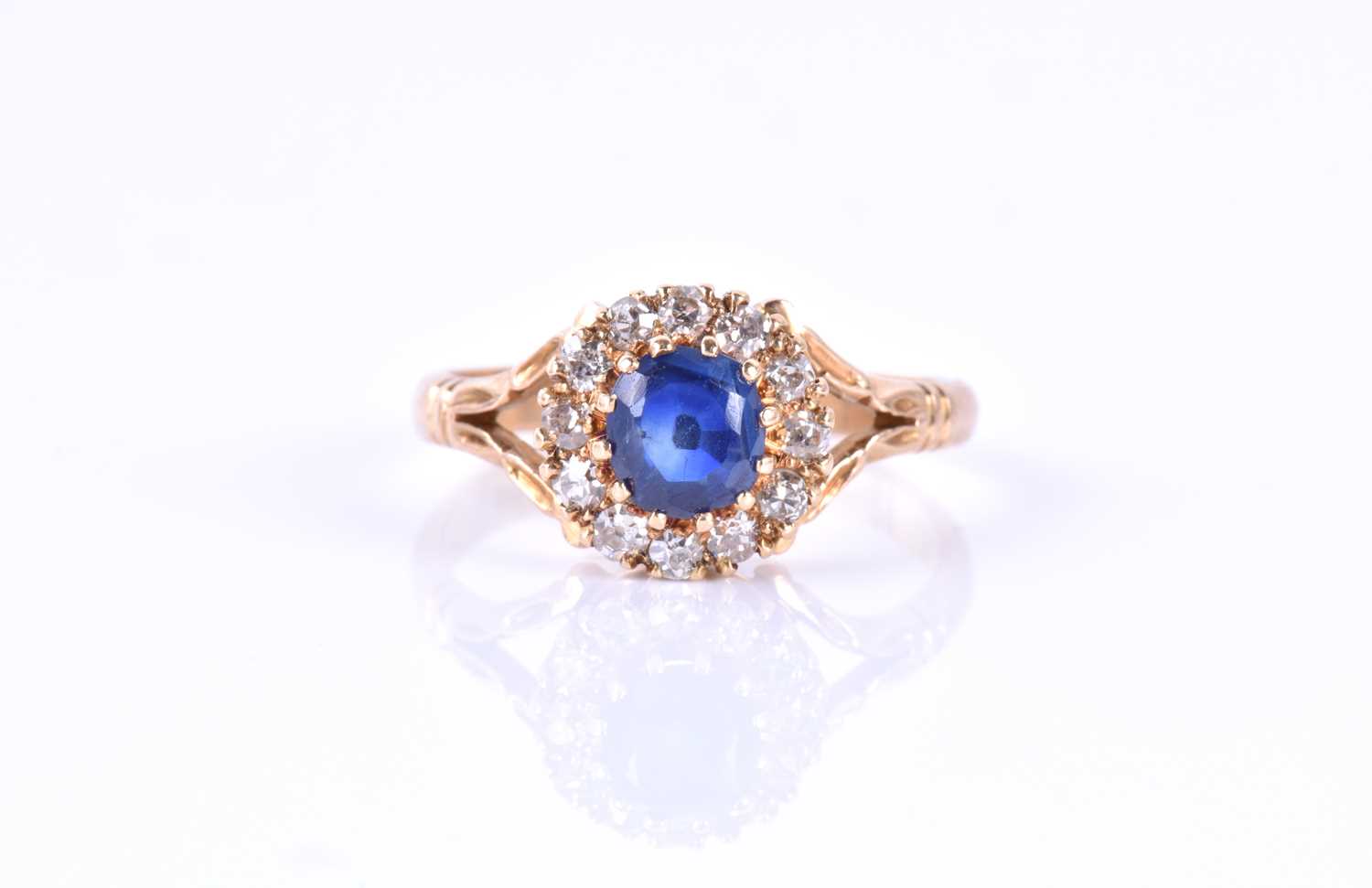 A yellow metal, diamond and sapphire cluster ringset with a mixed round-cut sapphire, measuring