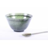 A Chinese spinach green bowenite bowl with jade spoon, 20th century, the bowl with interior lip,