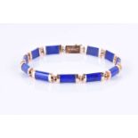 A yellow metal and lapis lazuli braceletcomprised of rectanguar links with gold terminals, the clasp