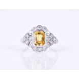 A platinum, diamond, and yellow sapphire ringcentred with a mixed rectangular-cut sapphire of