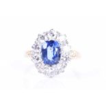 An 18ct yellow gold, diamond, and sapphire cluster ringset with a mixed oval-cut sapphire of