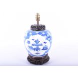 A Chinese blue and white ginger jar, late 19th century, decorated with two shaped cartouches