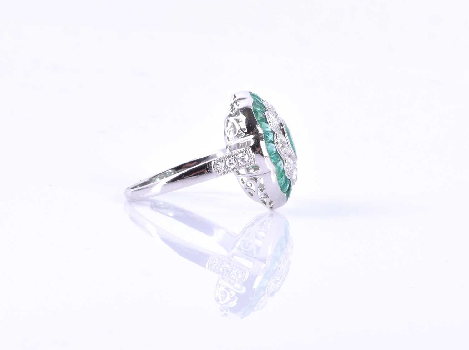 A diamond and emerald cocktail ringcentred with a mixed oval-cut emerald, within a border of round - Image 2 of 5