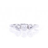 A platinum and diamond ringcollet-set with three round-cut diamonds of approximately 0.75 carats