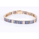 An 18ct yellow gold, diamond, and sapphire line braceletthe articulated segments channel-set with