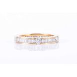 An 18ct yellow gold and diamond eternity ringcalibre-set with mixed baguette-cut diamonds