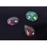 A group of three loose cabochon opalsincluding a pear-shaped opal of 1.84 carats, and two rounded