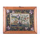 A 19th century needlework tapestry depicting animals to the central panel, within a foliate