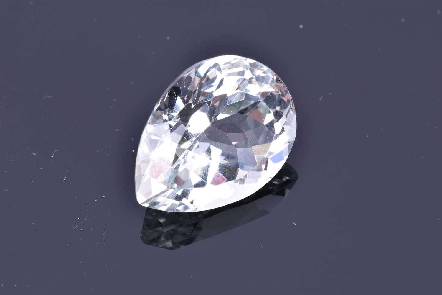 A loose mixed pear-cut pale blue topazof approximately 17.45 carats. Please note: VAT will be