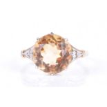 A yellow metal and citrine ringset with a mixed round-cut citrine, approximately 11mm diameter,
