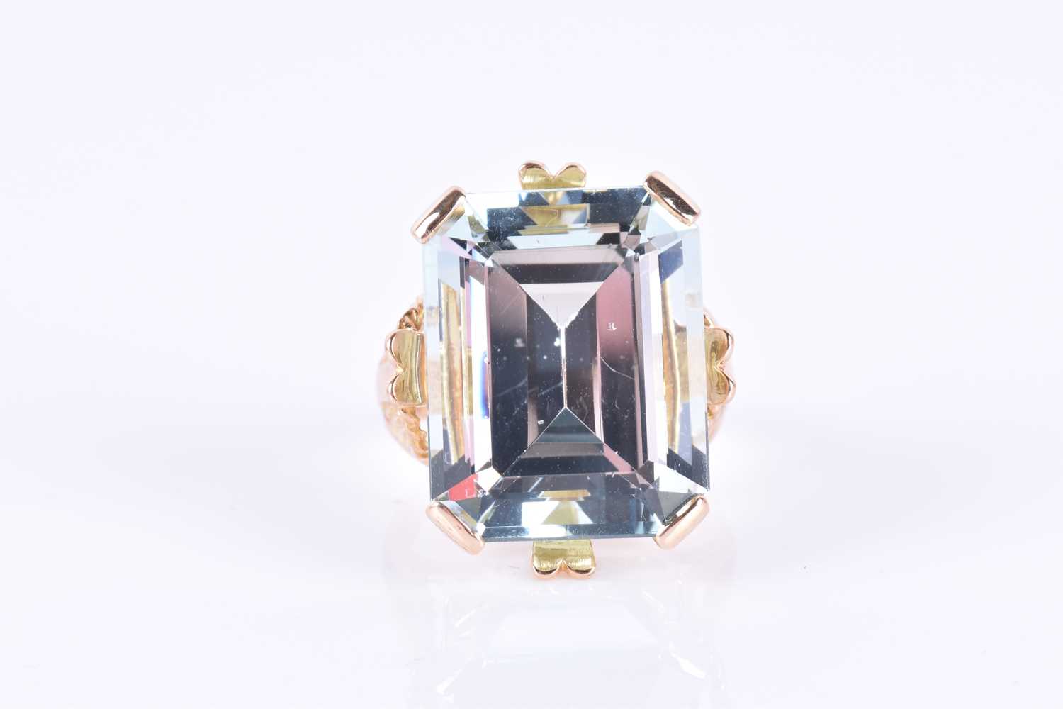 A yellow gold and aquamarine cocktail ringset with a large emerald-cut aquamarine of approximately