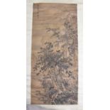 A large Chinese hanging silk scroll painting, Qing, depicting a scholar in a retreat beneath tall