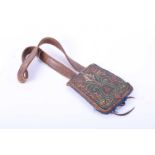 A Persian leather shoulder bag/purse, with coloured thread floral decoration against a gilt thread