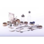 A small collection of silver items, comprising a cigarette box, five napkin rings,two silver mounted