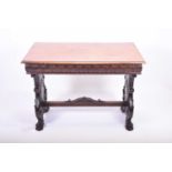 A Victorian carved oak library table the plain top over foliate-carved frieze, each end with lion
