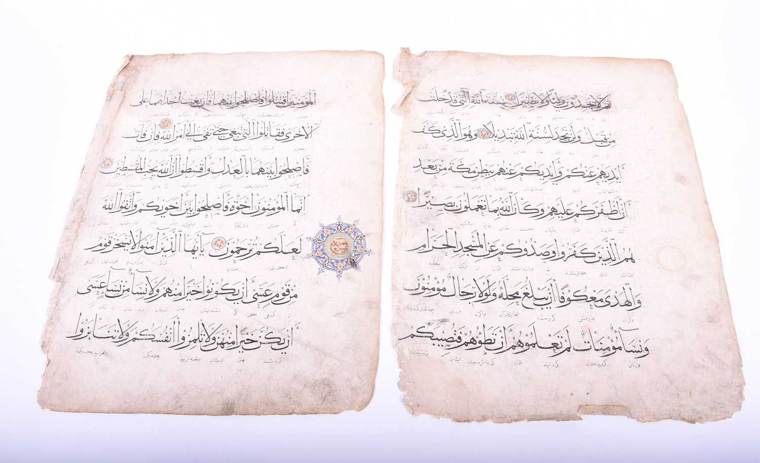 Two leaves of Persian script, 18th century, each with illuminated roundels, 40.5cm x 31cmCondition