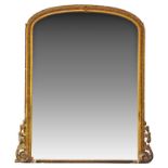 A large Victorian overmantel gilt wall mirror, with slightly arched top and moulded frame with