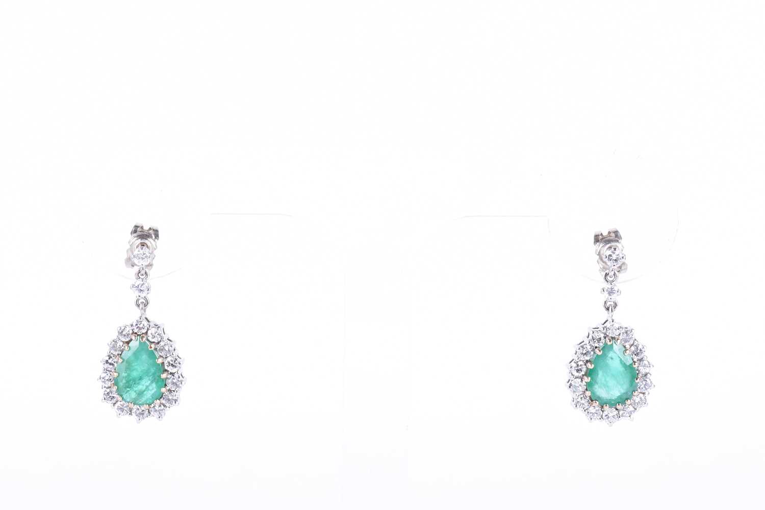 A pair of white gold, diamond, and emerald drop earringseach set with a mixed pear-cut emerald,