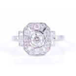 A platinum and diamond cluster ringcentred with a collet-set diamond, the openwork chamfered