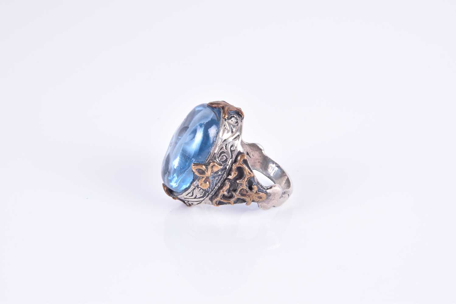 An unusual silver and blue glass ringset with an oval blue glass cabochon, of stylised - Image 2 of 3