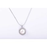 A 14k white gold, diamond, and pearl pendantset with a white cultured pearl, approximately 9 mm,