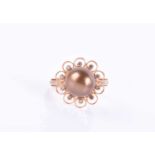 An 18ct rose gold, diamond, and chocolate pearl ringset with a dark bronze-coloured pearl within a