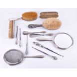 A collection of silver mounted dressing table accessoriescomprising five brushes, two hand held