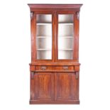 A late Victorian walnut veneered bookcase, with adjustable shelves on a cupboard base with single