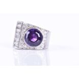 An Art Deco diamond and amethyst cocktail ringset with a mixed round-cut amethyst, the asymmetric