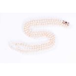 An opera length double strand pearl necklacecomprising of white cultured pearls, approximately 74 cm