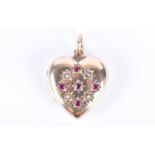 A 9ct yellow gold heart-shaped locket pendantwith star-cut decoration inset with small diamonds