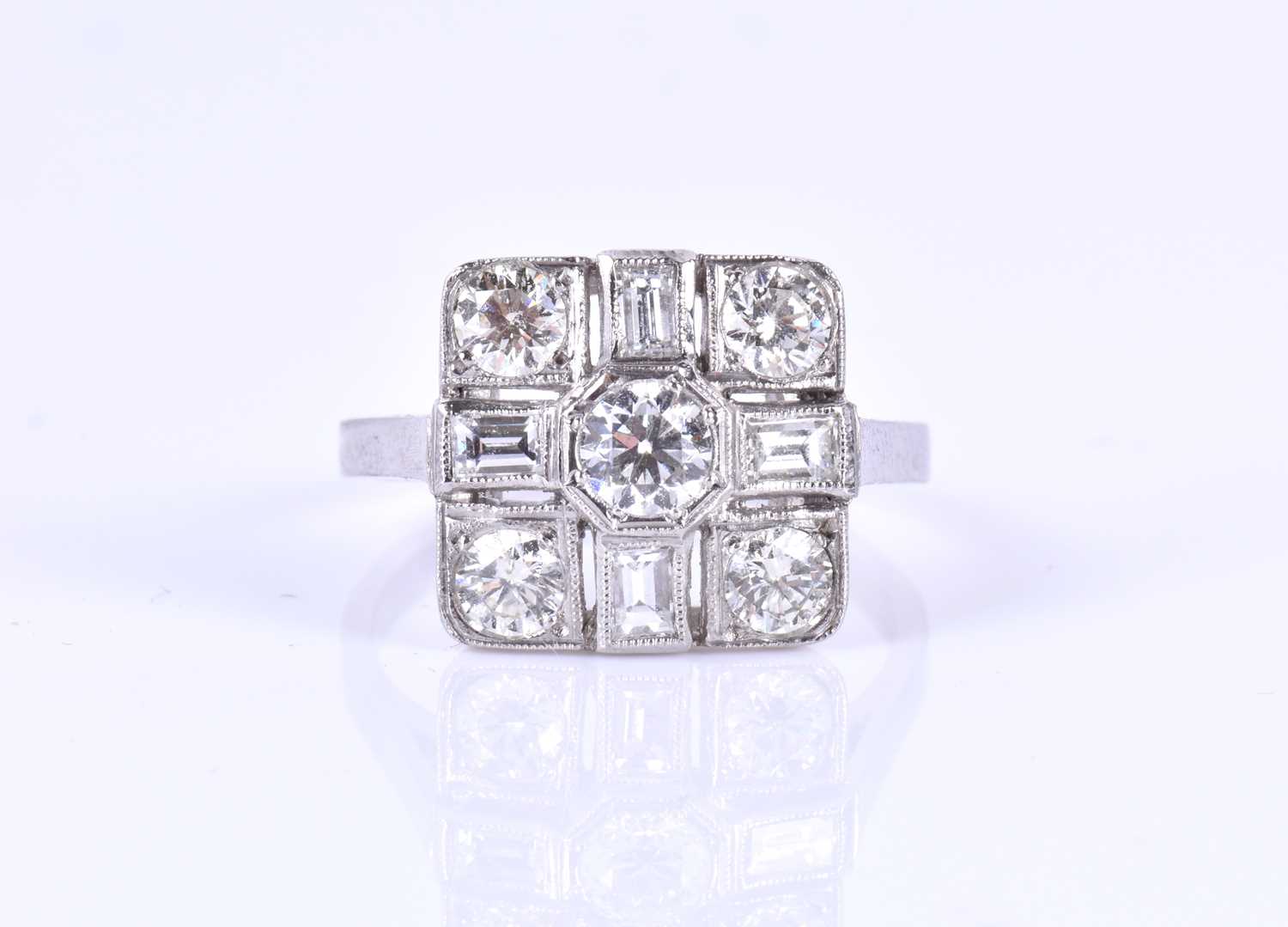 A platinum and diamond ringin the Art Deco style, set with round-brilliant and baguette-cut diamonds