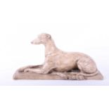A model of a recumbant Greyhound, late 20th century, naturalistically modelled resting upon a