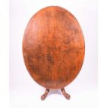 A Victorian quarter-veneered walnut oval loo table the tilt-top on a turned column, with four