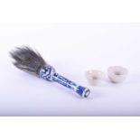 A Chinese blue and white calligraphy brush, 19th century, the brush head decorated with dragons