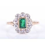 An 18ct yellow gold, diamond, and emerald ringcentred with a mixed emerald-cut emerald, measuring