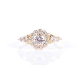 A diamond floral cluster ringcentred with a round brilliant-cut diamond of approximately 0.57