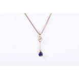 An 18ct yellow gold, diamond, and sapphire pendantset with an old round-cut sapphire of