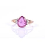 A 9ct yellow gold, pink sapphire, and diamond ringset with a pear-cut dark pink sapphire flanked