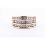 A yellow gold and diamond band ring, set with three channel-set rows of round brilliant-cut