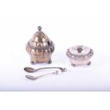 A Georg Jensen attributed condiment pot, with matching silver salt pot and two silver spoons, the