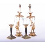 A pair of gilt metal figural table lamps, late 19th century, each modelled as a soldier in partial