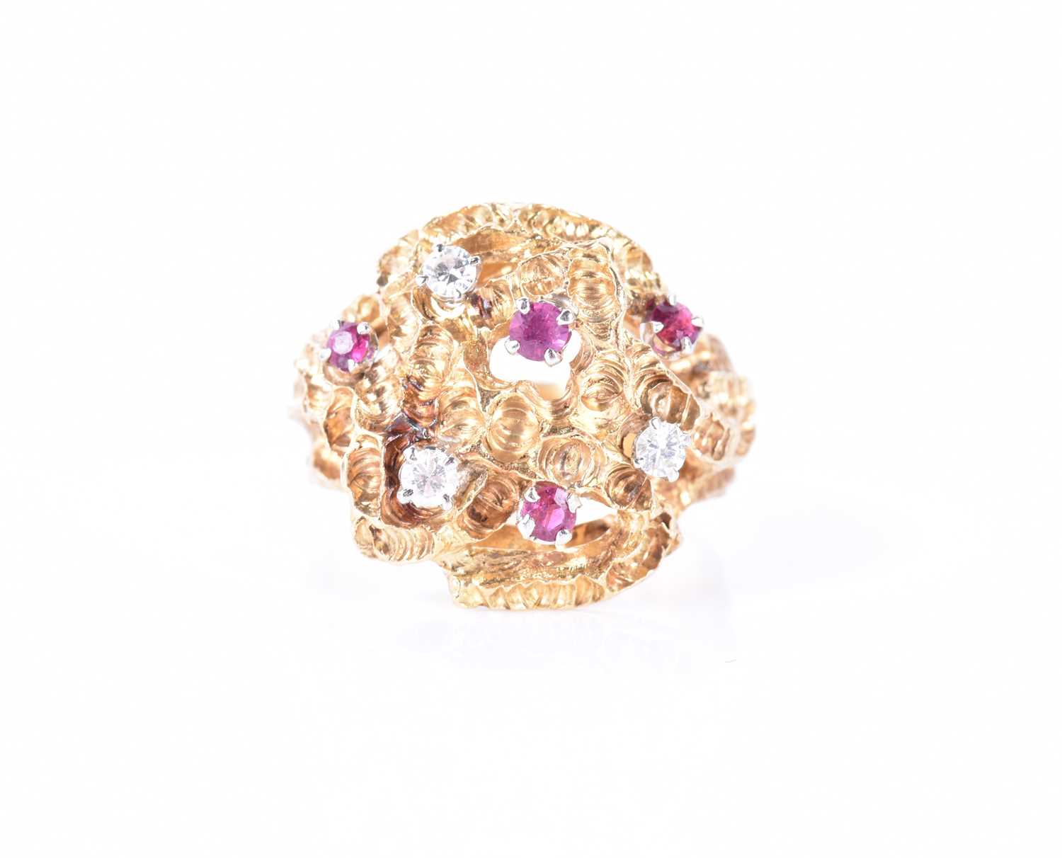 An unusual 1960s 18ct yellow gold, diamond, and ruby ringof Modernist design, the textured mount