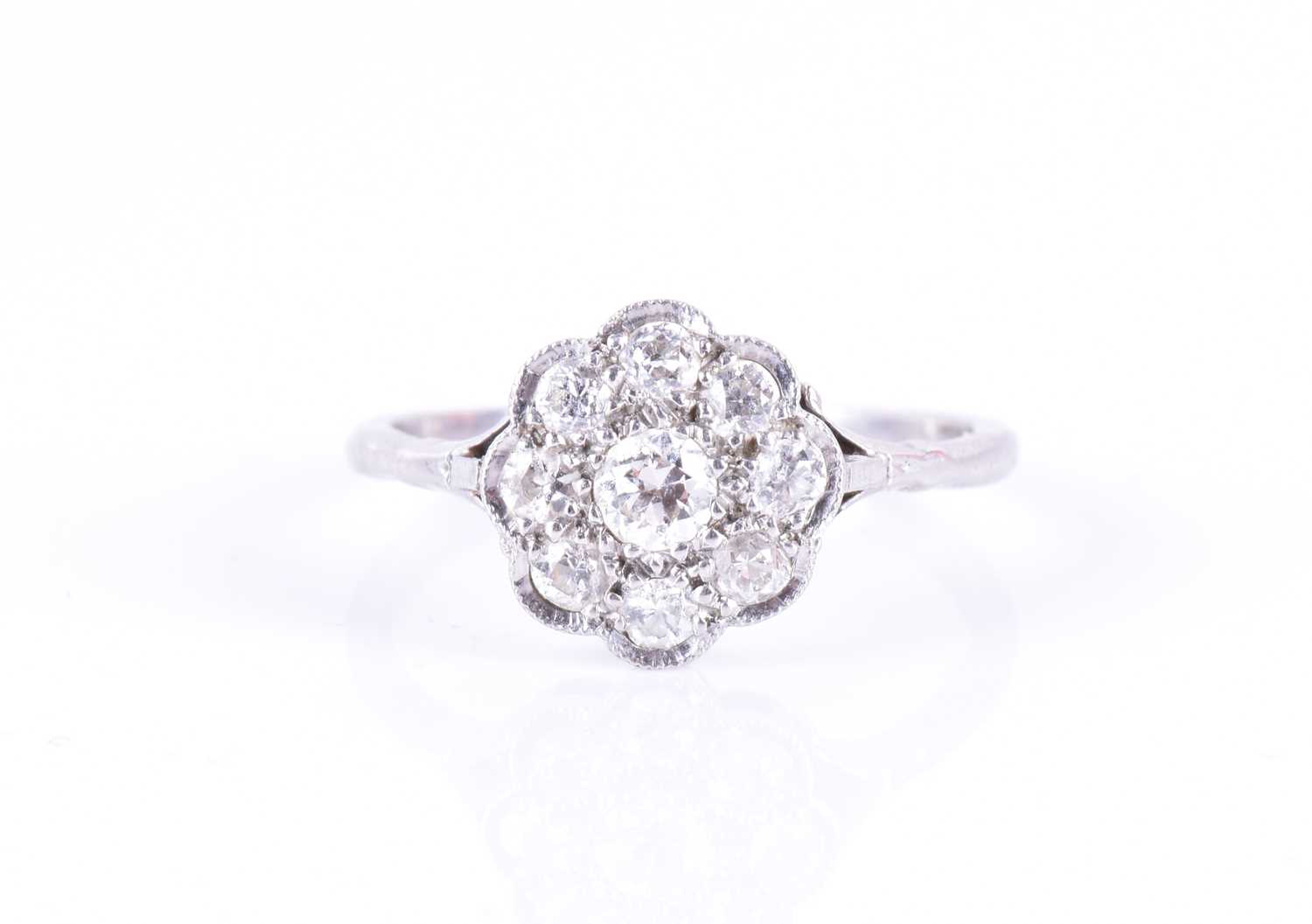 An early to mid 20th century diamond floral cluster ringset with round-cut diamonds of approximately
