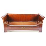 A French Empire style mahogany day bed, each end with a carved swans head terminal, with panelled