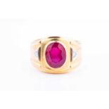 A yellow metal, synthetic ruby and diamond ring, the wide band inset with a mixed-cut ruby, the