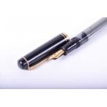 A vintage Pelikan fountain pen, with grey marbled body and black end caps and cover, with gilt metal