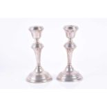 A pair of Regency style silver candlesticks Birmingham 1973, by W.I Broadway & Co, designed with